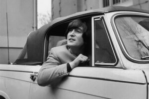John Lennon is one of several famous people who own vintage Mercedes-Benz cars; here is a picture of him in his 1965 Mercedes 